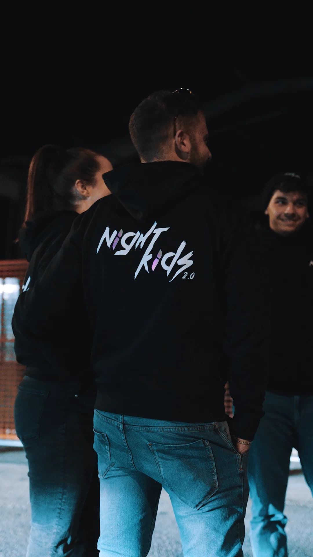NightKids members wearing the team hoodie at night